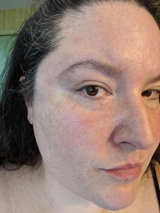 A reviewer wearing the concealer to display its effects