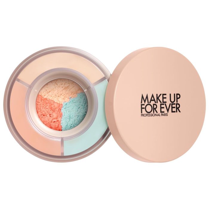 A Make Up For Ever Professional Paris compact finishing powder featuring four distinct sections in shades of peach, light blue, and beige, displayed with its lid open.