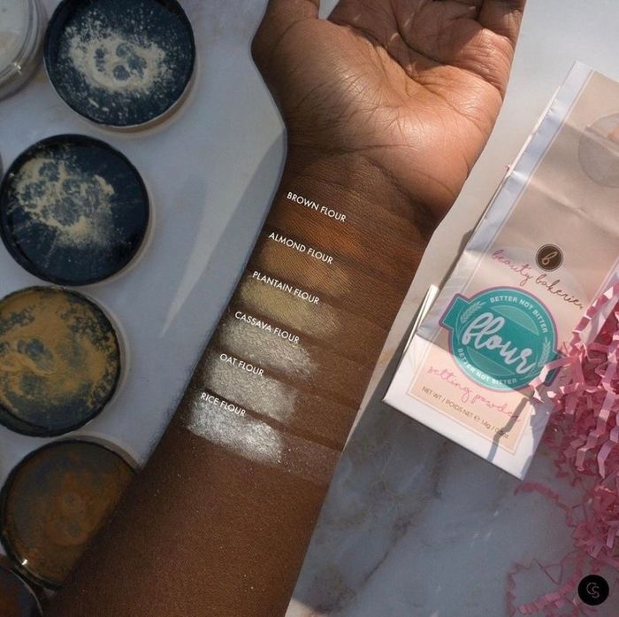 a model’s arm showcasing swatches of the setting powder in different shades