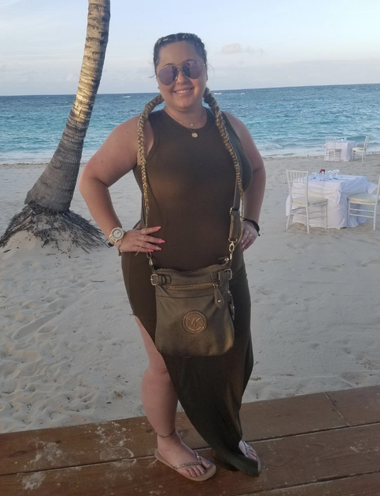 reviewer modeling an olive green high-neck dress