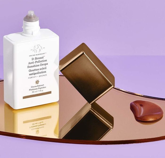 the serum bottle alongside a small pool of the bronze serum