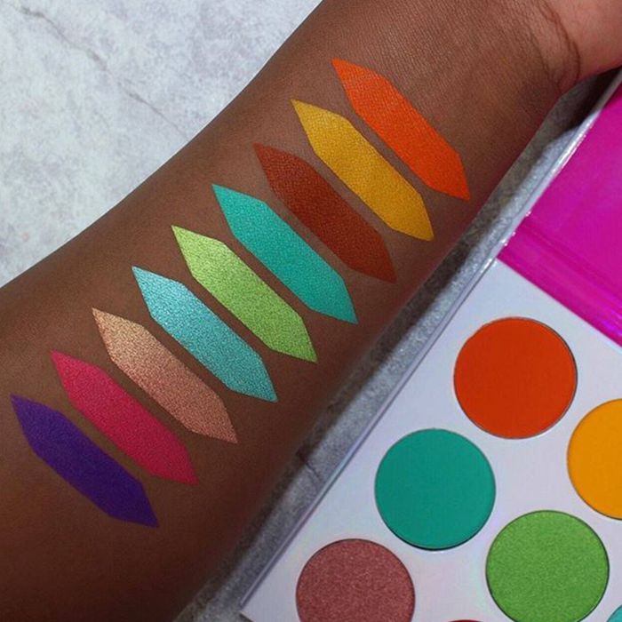 a model's arm showcasing swatches of the diverse eyeshadow shades