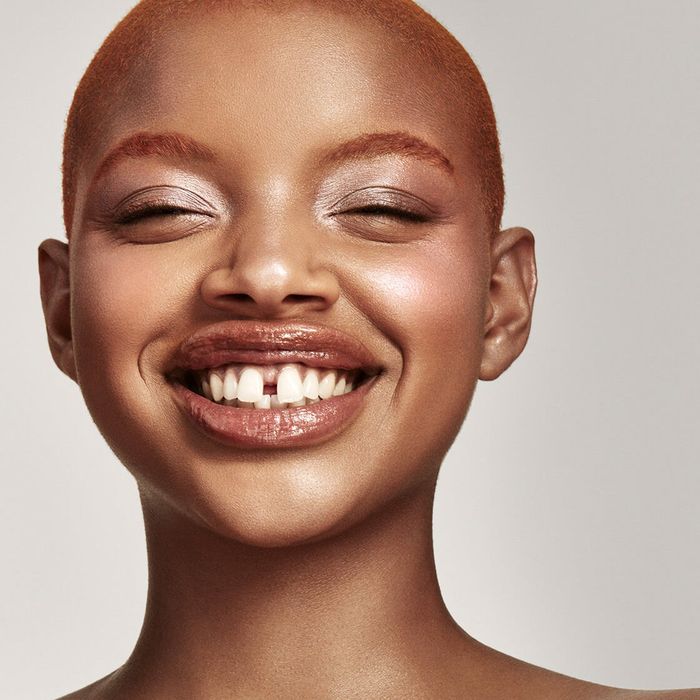 a Black model wearing the killawatt freestyle highlighter duo in LIGHTNING DUST / FIRE CRYSTAL on their face