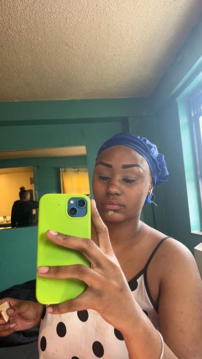 A before photo of a reviewer applying the product as a makeup primer, without foundation.
