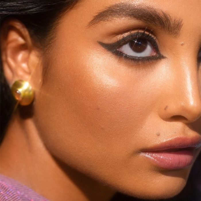 a model showcasing a bold cat-eye look created with the black eyeliner