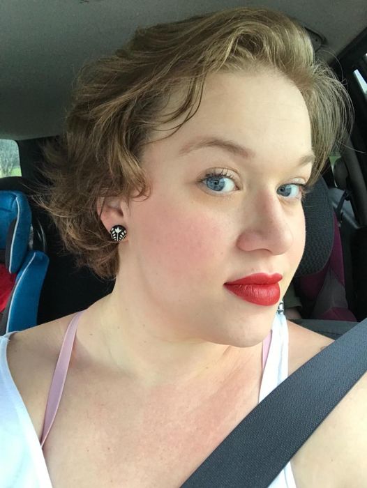 a reviewer photo of them wearing the matte liquid lipstick in a vibrant red shade