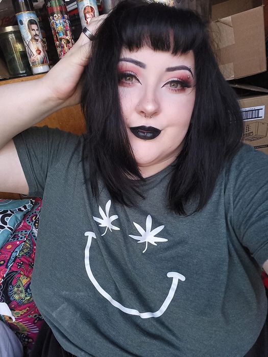 a reviewer photo of them wearing the matte liquid lipstick in a bold black shade