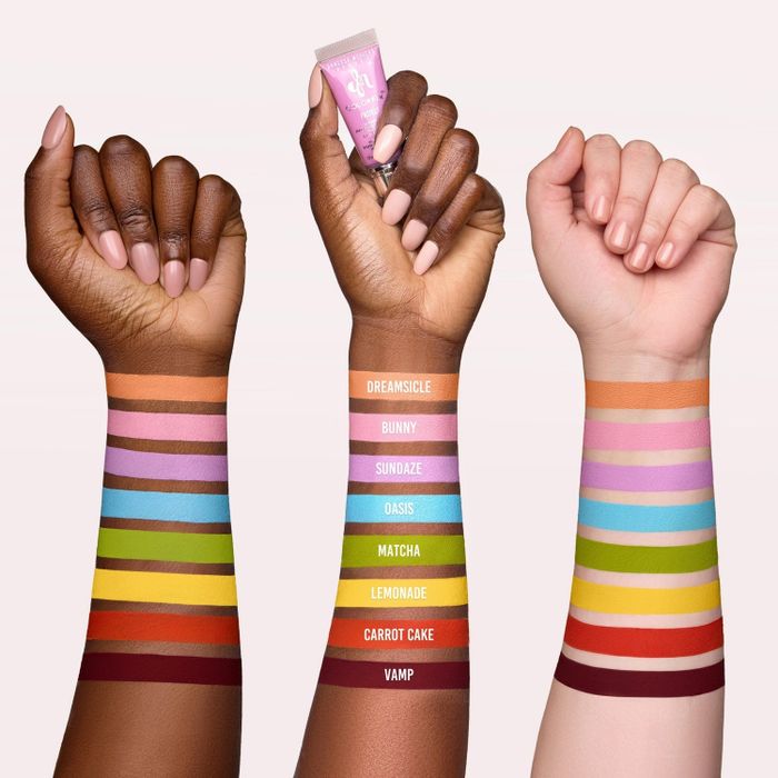 Three arms presenting a range of lipstick shades in colors labeled Dreamsicle, Bunny, Sundaze, Oasis, Matcha, Lemonade, Carrot Cake, and Vamp.