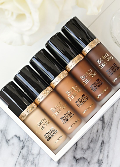 Five bottles of concealer displayed in a range of shades from light to dark.