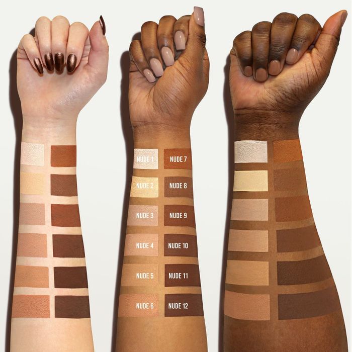 Three arms with different skin tones showcasing foundation swatches labeled from Nude 1 to Nude 12.