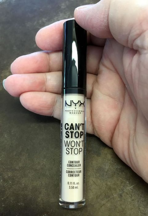 A reviewer holding the concealer tube