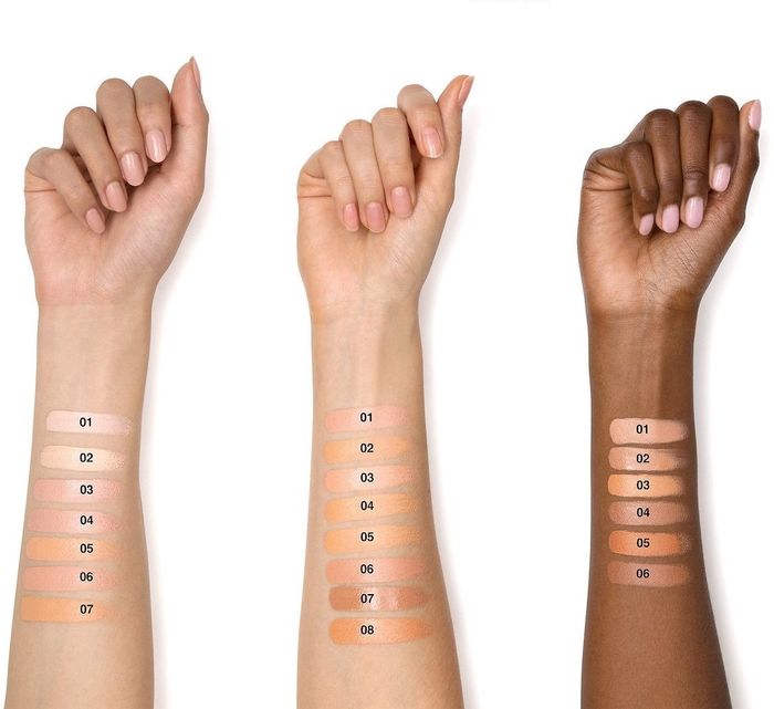three models’ arms displaying swatches of the under-eye corrector in various shades