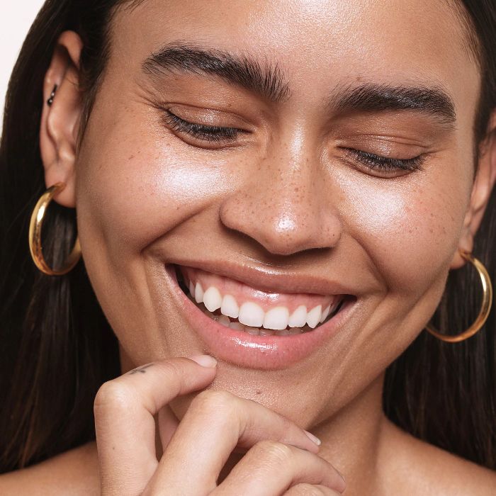 a model showcasing a radiant glow achieved with the gel highlighter
