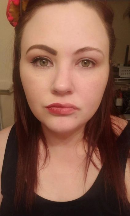 A reviewer with one side of their face made up, and the other side makeup-free after using the eraser