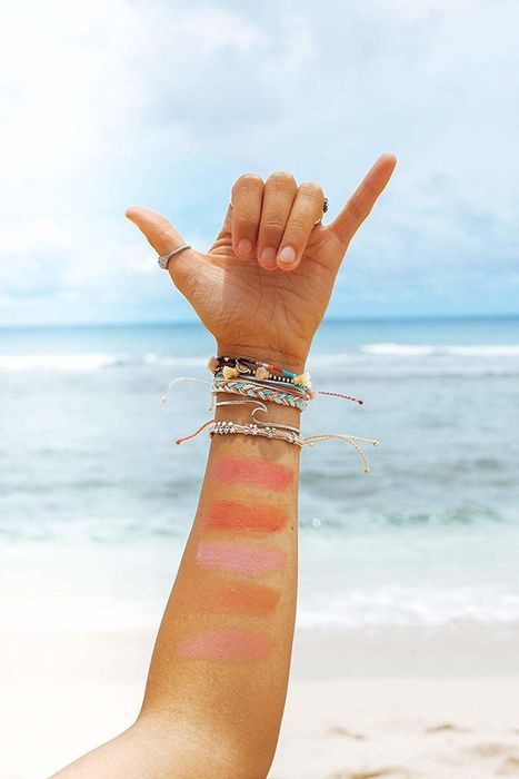 A model's arm displaying swatches of various colors