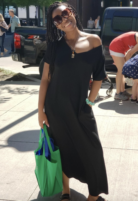 reviewer modeling a black maxi dress