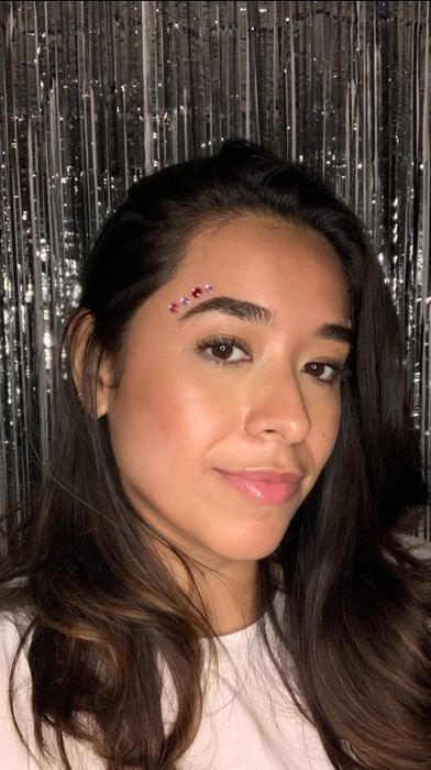 A reviewer showcasing radiant, glowing skin.