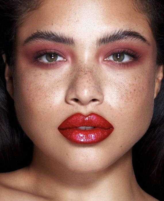 a model flaunting bold red lip pigment