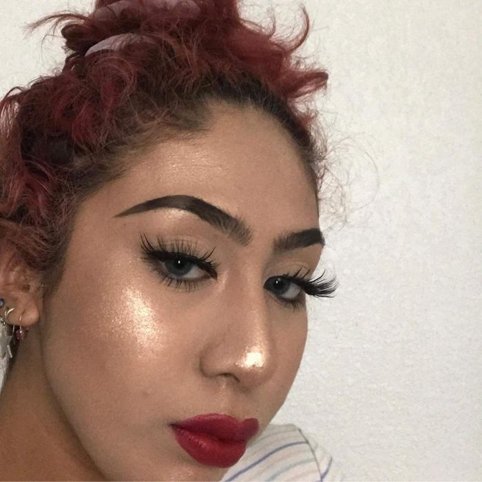 a reviewer photo showcasing the golden highlighter reflecting beautifully on their face