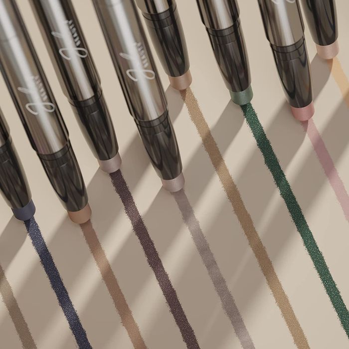 nine eyeshadow sticks swatched on a surface, showcasing their vibrant colors