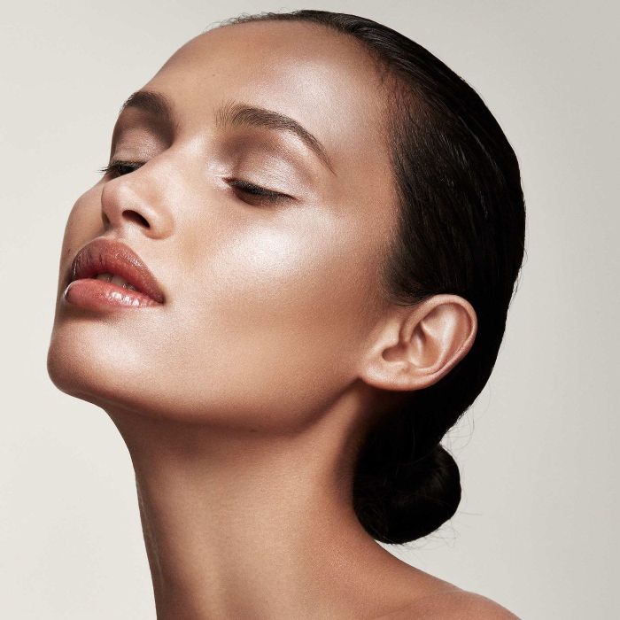 a model showcasing the highlighter applied to their face