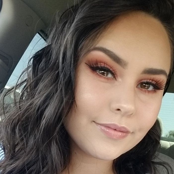 A reviewer showcasing the concealer applied to their skin