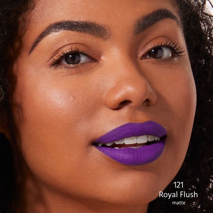 a model wearing a bold purple lipstick