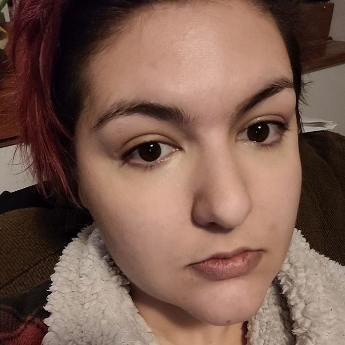 A reviewer showcasing the concealer applied to their skin