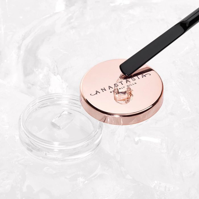 a container of the clear brow wax featuring a gold cap