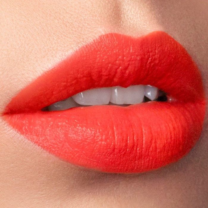 a close-up view of vibrant red-orange lips