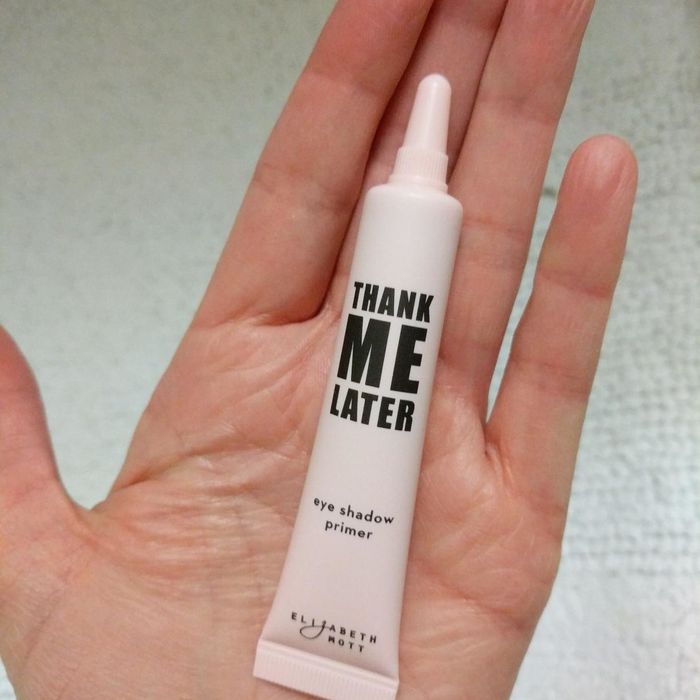 A reviewer holding the product tube