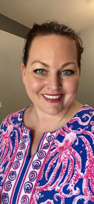 Smiling reviewer with a full face of flawless makeup