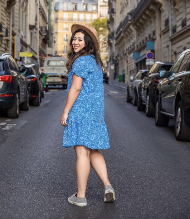reviewer wearing a blue dress