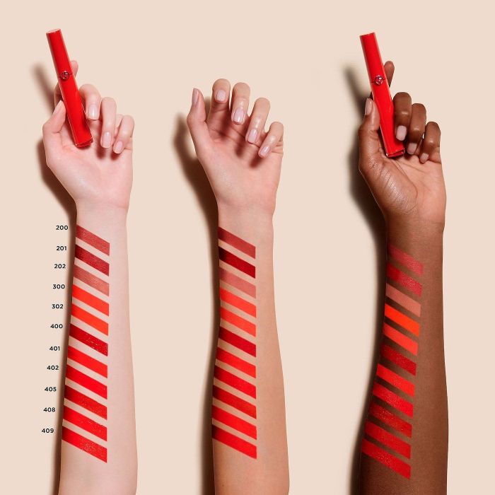 three models' arms featuring swatches of the lipstick's diverse shades
