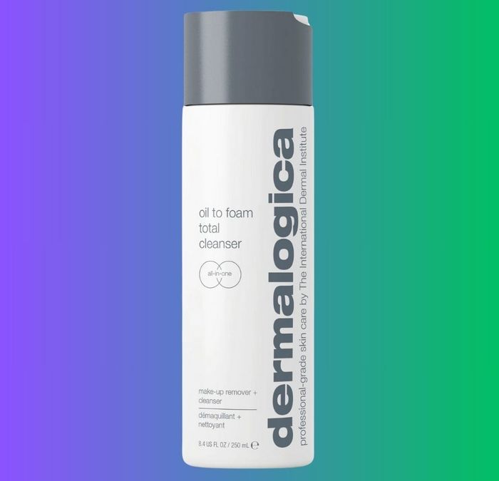 A bottle of Dermalogica Oil to Foam Total Cleanser showcased on a gradient background