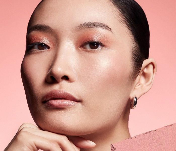 a model showcasing Nars' iconic Orgasm blush