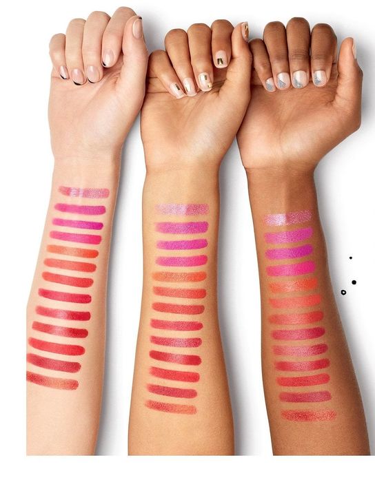 three models' arms displaying swatches of the lipstick in various shades
