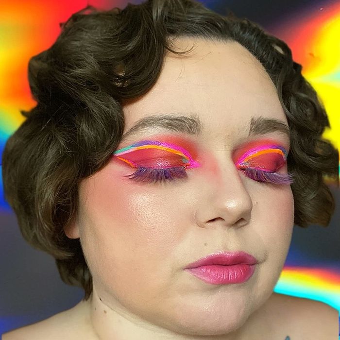 a reviewer wearing the tinted hydrator paired with vibrant and colorful makeup
