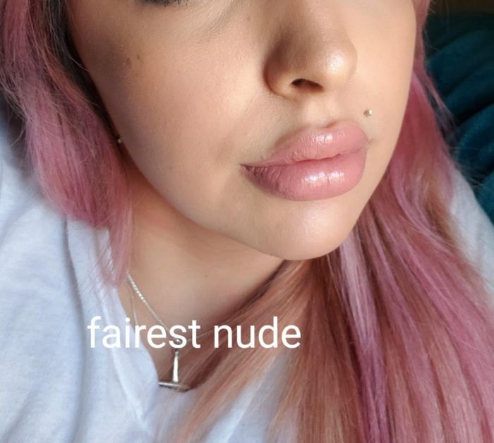 a reviewer photo of their lips wearing the lipstick, accompanied by text that says