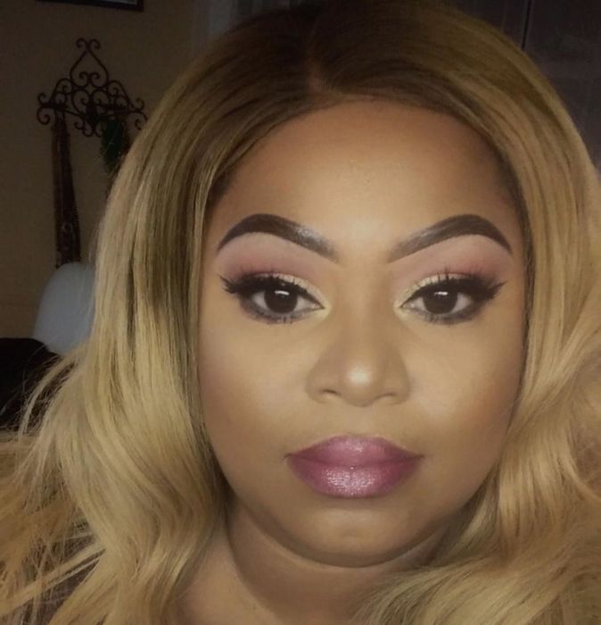 Black reviewer showcasing a glamorous eyeshadow look