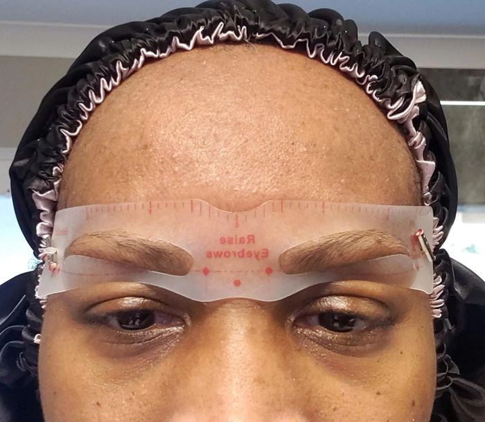 A reviewer wearing one of the included eyebrow stencils.