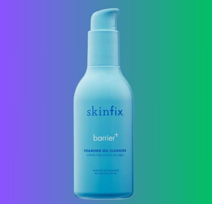 A bottle of Skinfix Barrier+ Foaming Oil Cleanser set against a gradient background