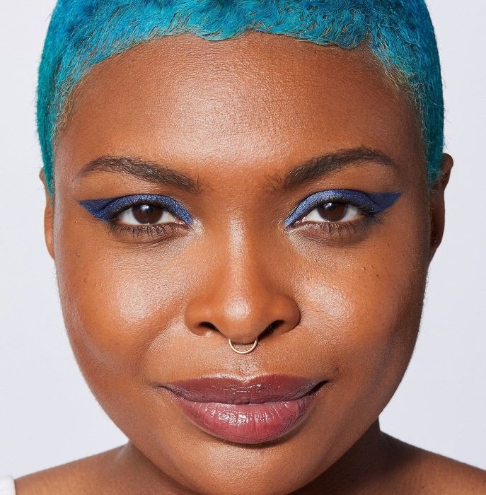 a model showcasing the blue eye makeup for a striking look