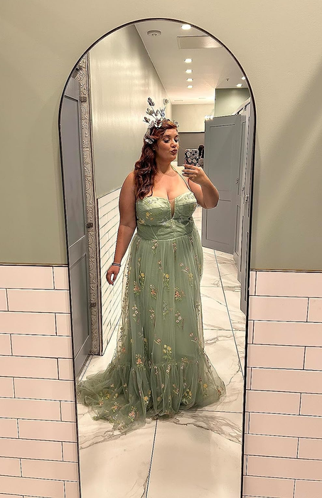 reviewer showcasing a beautiful green tulle gown