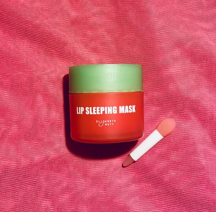 Lip Sleeping Mask container and applicator placed on a textured surface
