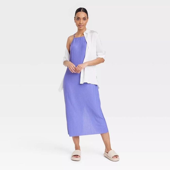 A model showcasing the lavender dress paired with a white button-up