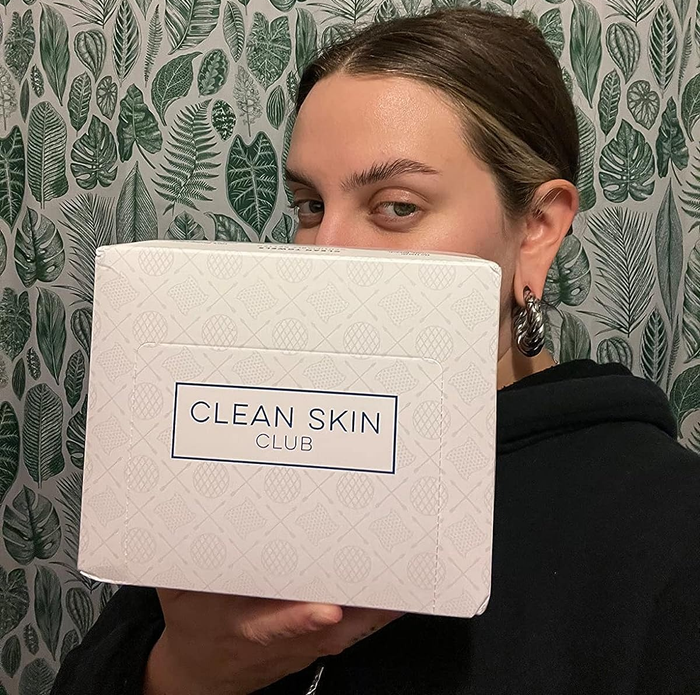 Reviewer holding up a box of disposable face towels