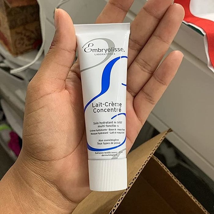 The reviewer is seen holding a moisturizer.