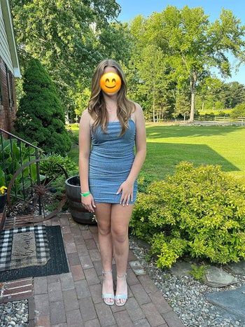 reviewer showcasing a dazzling blue glitter mini dress