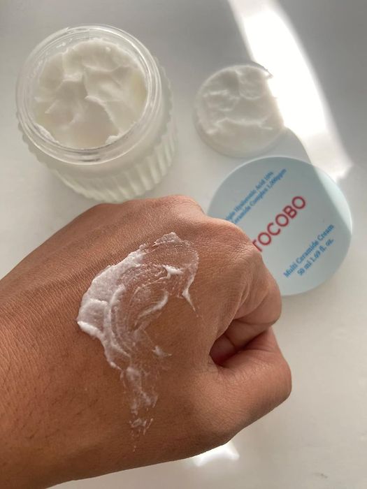 A reviewer with a small amount of the moisturizer on their hand